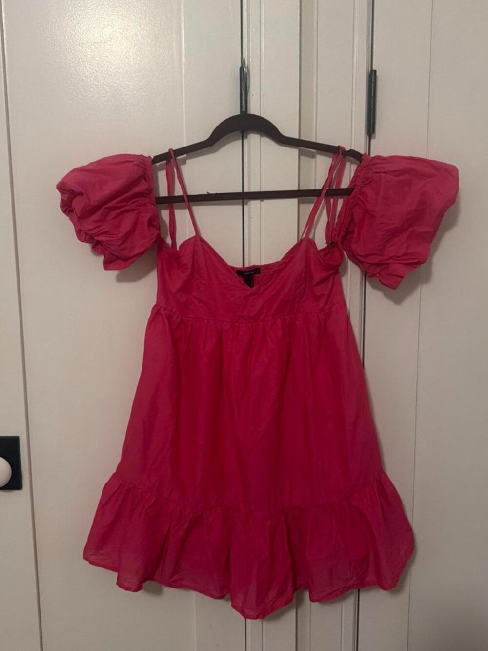Pink mini dress with ruffled sleeves and hem